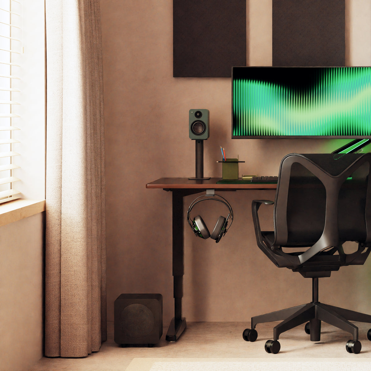 A modern desk setup in a warm brown room, featuring a black desk with a hook holding over-ear headphones, a black ergonomic chair, a speaker, and a computer monitor.